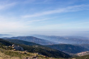 Bulutlu bir gökyüzünün altındaki dağ resmi