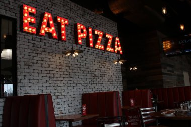 Columbus, Ohio February 19, 2021 Italian Eatery with lighted Eat Pizza sign.