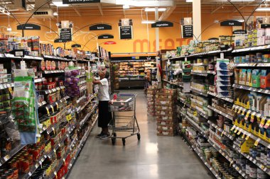 Los Angeles CA 11 Eylül 2025 Alışverişçi market koridorundan gıda ürünleri seçiyor.