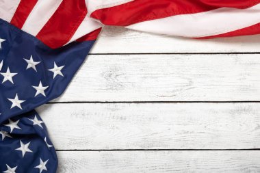 Flat lay USA flag on white wooden board, vintage background with copy space top view. Banner, minimalism. American