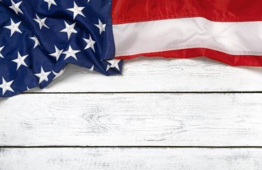 Flat lay USA flag on white wooden board, vintage background with copy space top view. Banner, minimalism. American