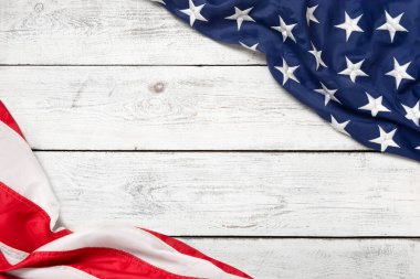 Flat lay USA flag on white wooden board, vintage background with copy space top view. Banner, minimalism. American