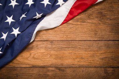 Flat lay USA flag on brown wooden board, vintage background with copy space top view. Banner, minimalism, loft style. American