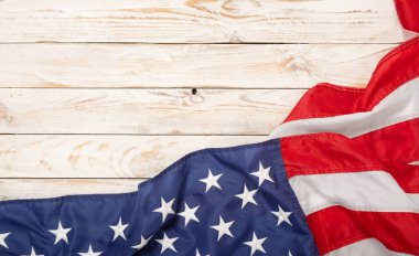 Flat lay USA flag on white wooden board, vintage background with copy space top view. Banner, minimalism. American