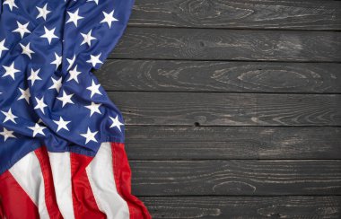Flat lay USA flag on black wooden board, vintage background with copy space top view. Banner, minimalism, loft style. American