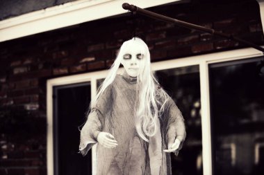 Beyaz ölüm. Canavar kadın. Ekim 'de Cadılar Bayramı için sahne. Bahçedeki dekorasyon..