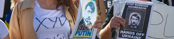 Santa Monica, California, USA - February 25, 2022: Stop Putin, stop war. Stand with Ukraine. Russia war against Ukraine, aggressive invasion. Ukrainians, Russians, Belarusians against Russia. — Free Stock Photo