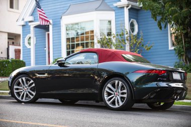 USA - 2020: Black and red elegant super car in a the street in the US. Retro travel jorney life style. A convertible or cabriolet, a passenger car