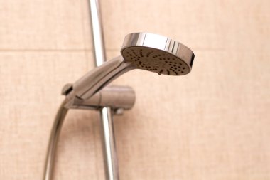 Banyoya yakın duş başlığında su damlaları var..