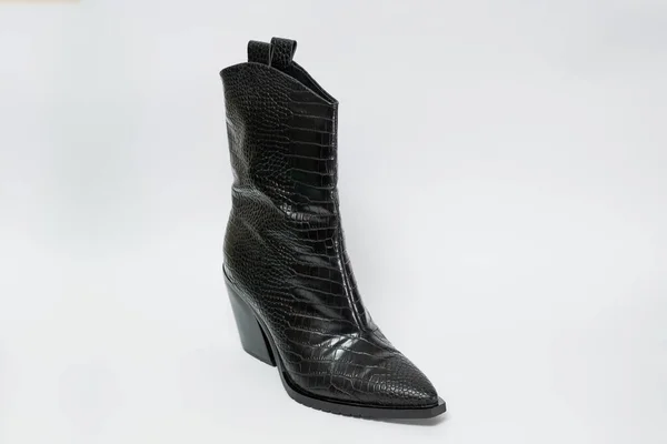 Black leather women\'s shoe isolated on white background.