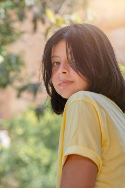 Güzel bir genç kızın açık hava portresi. Güzel genç kız kameraya poz veriyor..