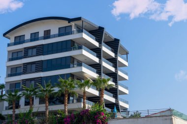 Modern apartment building with large balconies on a sunny day. Southern architecture.