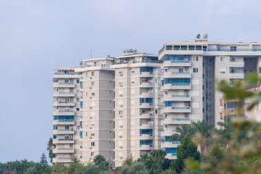 Several modern tall apartment buildings. Early morning.