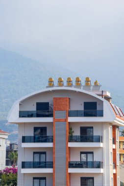 New residential building with solar water heaters on the roof. Urban architecture.