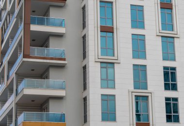 Modern high-rise building. A number of identical windows. Residential building.
