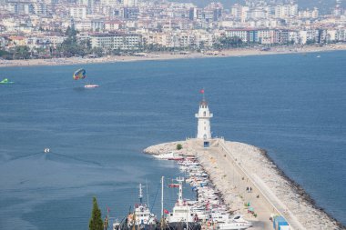 Alanya, Turkey - August 2022: Top view of the lighthouse and port in Alanya.