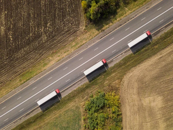 Aerial top down shot of highway with truck trailer and the car. — Stock Photo, Image