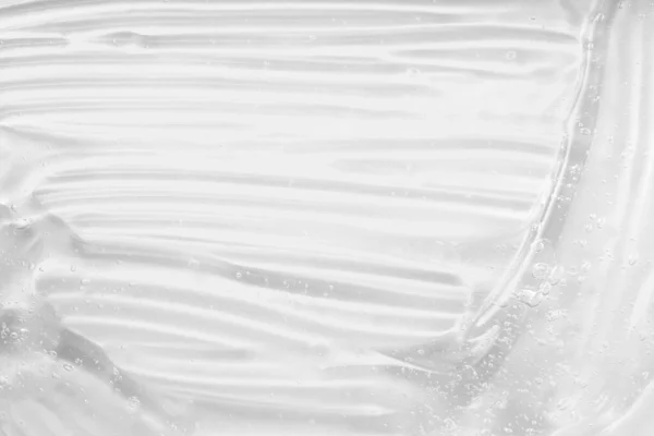 Crema cosmetica gel liquido trasparente. Acido ialuronico per la cura della pelle con collagene e retinolo. Lozione per la cura della pelle faccia campione di siero. Gel sbavatura su sfondo bianco. — Foto Stock