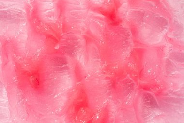 Nemlendirici ve temizleyici güzellik ürünü numunesi. Kozmetik doku arka planı. Pembe kremalı merhem.