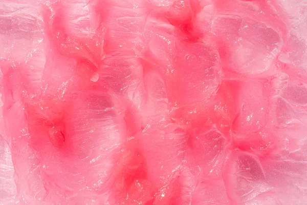 Nemlendirici ve temizleyici güzellik ürünü numunesi. Kozmetik doku arka planı. Pembe kremalı merhem.