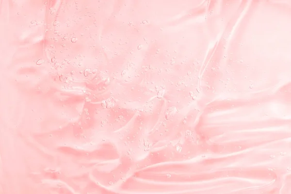 Muestra de textura sérica con colágeno y péptidos, gel líquido transparente con fondo de burbujas. Rosa transparente belleza cuidado de la piel muestra del producto. —  Fotos de Stock