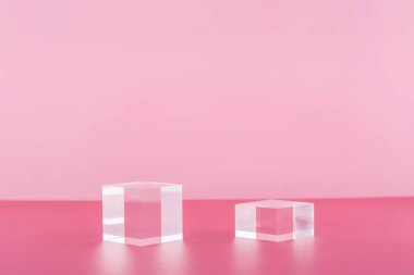 Pembe arka planda akrilik bloklar, ürün sunumu için kaidesel kozmetik cam podyum platformu, kozmetik için geometrik stand, mücevher sahnesi