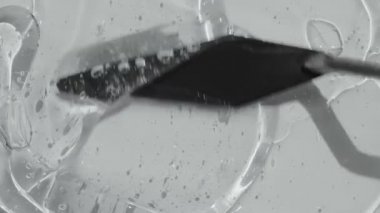 Toner beauty product with ceramide and collagen footage. Serum gel with peptides texture spreading with spatula footage. Hyaluronic acid cosmetic cleanser abstract video 4k