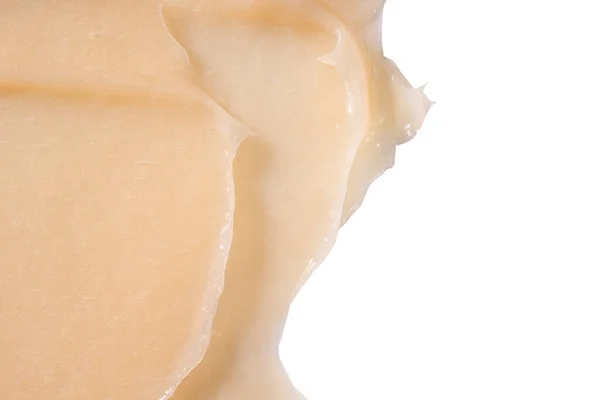 Frotis de crema acondicionadora para el cabello sobre fondo blanco. Primer plano de la muestra de crema hidratante de loción cosmética amarilla. Bálsamo para el cuidado corporal, suero de retinol, champú de textura ondulada. Mascarilla para el cuidado de la piel, limpiador cremoso —  Fotos de Stock