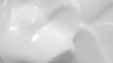 Beyaz krem, şampuan dokusu, güneş kremi makyaj arka plan videosu. Spatulalı nemlendirici krem kumaş örneği hareketi. Kremsi cilt losyonu. Krem sürme ürünü. Yakın çekim.