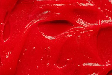 Kırmızı jel dokusu. Kozmetik temiz sıvı krem lekesi. Cilt bakım ürünleri numunesi yakın çekim. Diş macunu veya ağda arkaplanı