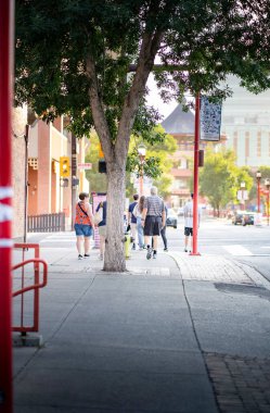 Calgary Alberta Canada, July 27 2022: A group of people standing at an intersection in China Town waiting to cross Center Street.