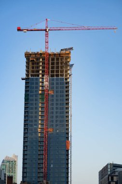 Calgary Alberta Canada, July 27 2022: A construction crane working on a high rise apartment building in the downtown core of a Canadian City.