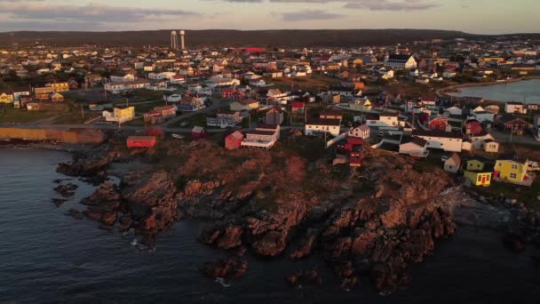 Aerial Orbital Newfoundland Coast Colourful Beach Homes Distant Water Towers — Stock Video
