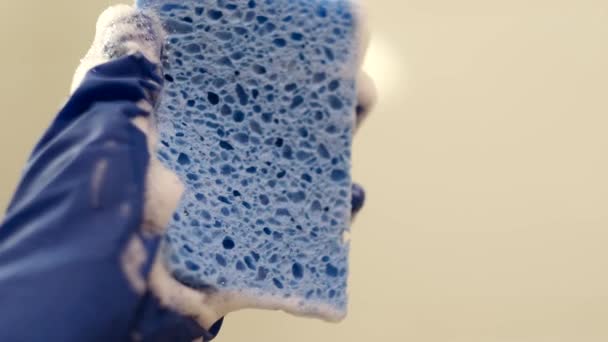 Hand Blue Rubber Glove Squeezes Out Blue Cleaning Sponge White — Stock Video