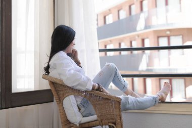 Kız pencereden dışarı bakıyor.