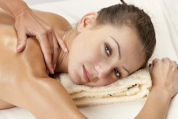 Relaxed woman receiving a shoulder massage — Stock Photo, Image