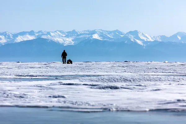 Backpacker walking on ice field. — Stock Photo, Image