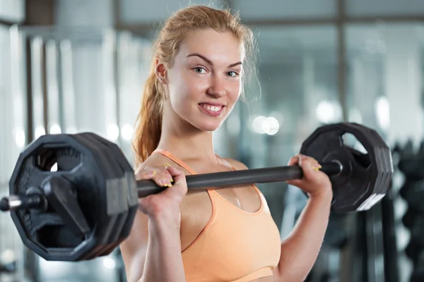 Woman doing workout with barbell — Stock Photo, Image
