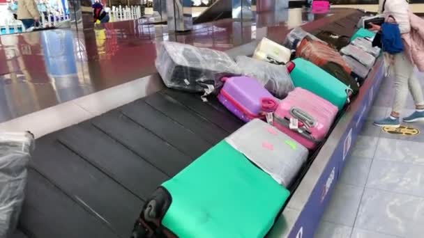 Mujeres en el aeropuerto con máscaras médicas llevándose su equipaje. Turismo de viaje durante la epidemia de coronavirus — Vídeos de Stock