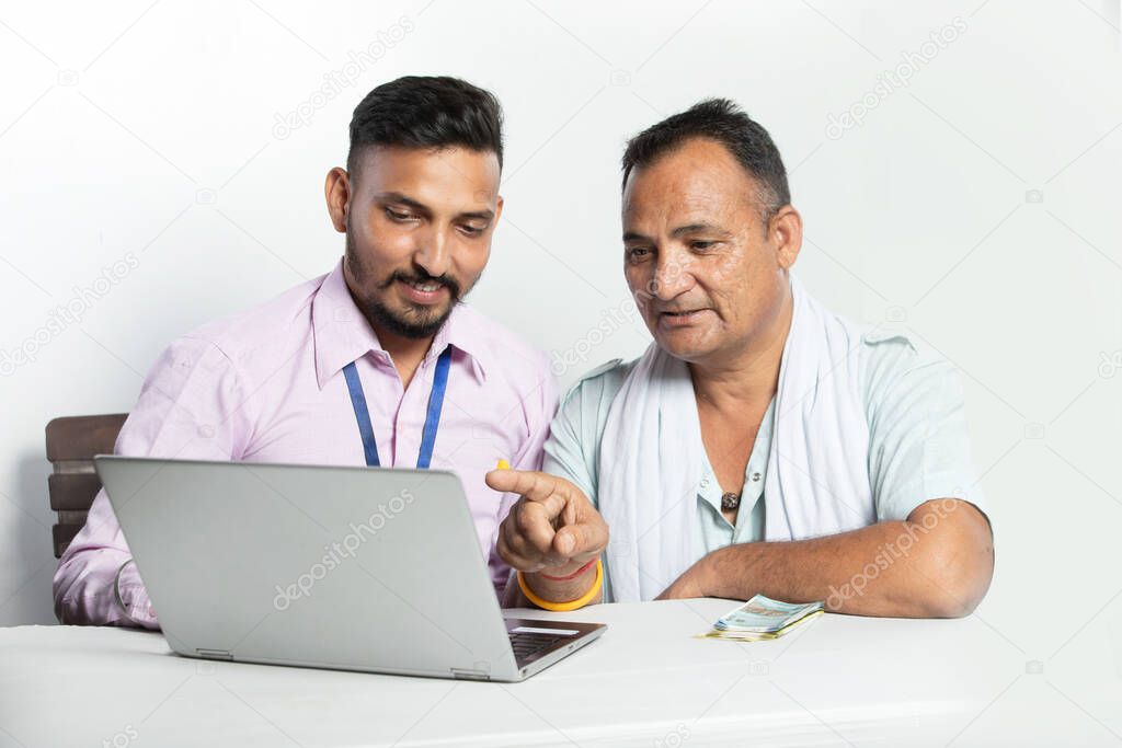 Indian man with bank sales person understanding policies and agreement on white background