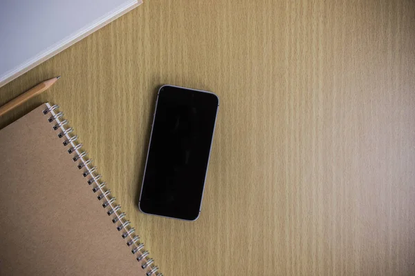 Black Notepad Pen Mobile Phone Wooden Table Top View 스톡 이미지