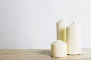 white candles on wooden background