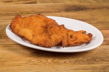a dish with spanish escalope de pollo a la milanesa, breaded chicken fillets.