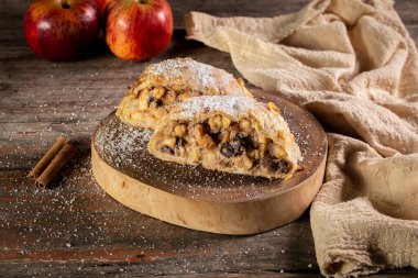  apple strudel with cinnamon and raisins , sprinkling powdered sugar on top. Austrian food from Germany.