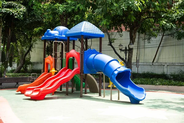 Colorful playground made of plastic empty outdoor playground set playground equipment.  Play area. Garden equipment. Children\'s slide. Playground in the park.