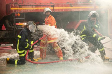 PICHIT , THAILAND - AUGUST 29 , 2022 - Unidentified firefighter test and practice using high-powered water to extinguish the fire. during the fire.