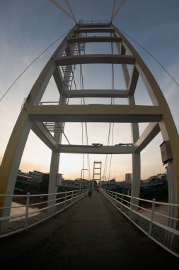 A pedestrian bridge across rivers and streams or canals.