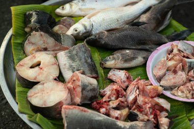 Animal products for cooking are sold at the street food market. Fresh fish meat is a popular traditional Thai food in the morning market.
