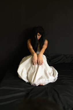 Korkunç Hayalet Kadın 'da Cadılar Bayramın kutlu olsun. Asyalı hayalet ya da zombi korkusunun tüyleri vardır. Yüzü ve gözleri kaplıdır. Terk edilmiş evde, karanlık odada kollarına uzanır.. 