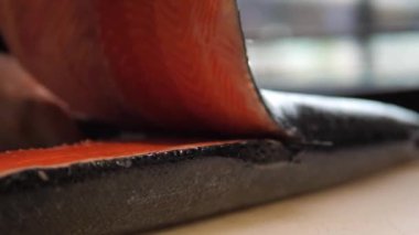 cutting carcasses of red fish. Italy.the chef cuts the red fish with a knife on the table. Italian food. male hands cut the carcass of a red fish with a knife